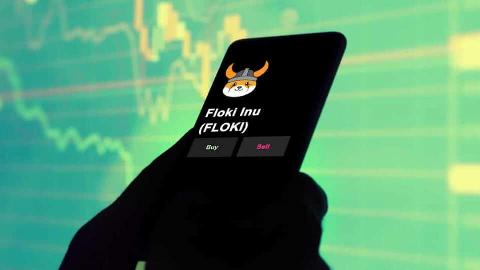 Smartphone mit Trading App zeigt Floki Inu Logo